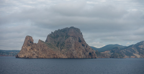 The island of es vedra from behind from a boat