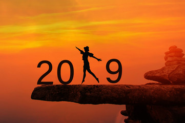 Silhouette of people jump and kick number 8 the rock with New year 2019 concept.