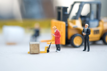 Miniature business man look workers carrying products. Cargo and shipping concept