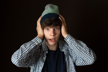 young man in casual portrait surprised emotion, exited isolated on dark background f