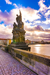 Statue on the Charles bridge in Prague. Historical ancient statue is placed on bridge over the Vltava river