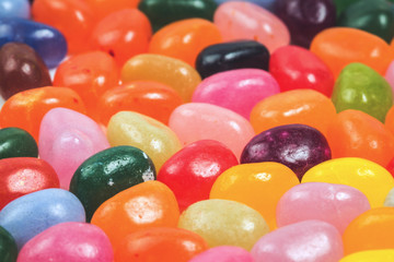 Fototapeta na wymiar Jelly bean sweets in close up macro background, side view with copy space