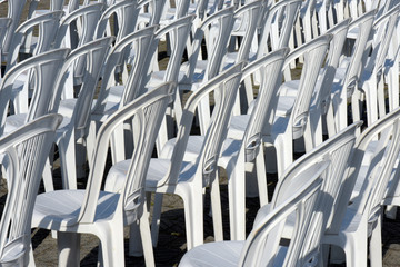 Composition with white chairs in outdoor auditorium