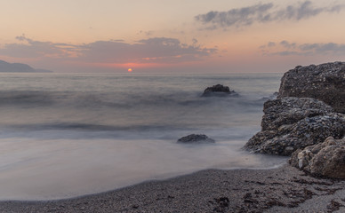 Fototapeta na wymiar Nerja, Malaga, Andalusi, Spain - November 17, 2018: Nice sunrise on Burriana beach, village of Nerja, Spain