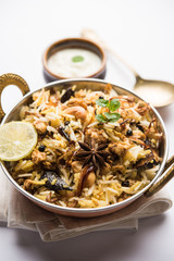 Keema or Kheema Biryani - Fragrant and spicy minced lamb or goat or chicken cooked in range of aromatic spices with basmati rice. served in a karahi with curd. selective focus