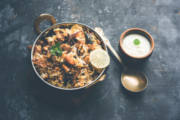 Keema or Kheema Biryani - Fragrant and spicy minced lamb or goat or chicken cooked in range of aromatic spices with basmati rice. served in a karahi with curd. selective focus