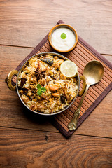 Keema or Kheema Biryani - Fragrant and spicy minced lamb or goat or chicken cooked in range of aromatic spices with basmati rice. served in a karahi with curd. selective focus