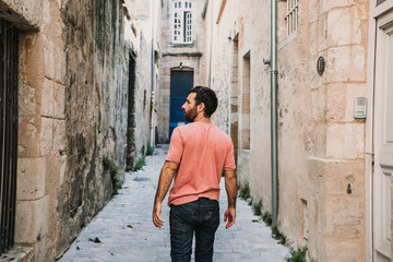 .Young man doing sightseeing around the beautiful city of Bordeaux in France. Feeling free and happy discovering new places. Travel photography.