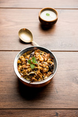 Keema or Kheema Biryani - Fragrant and spicy minced lamb or goat or chicken cooked in range of aromatic spices with basmati rice. served in a karahi with curd. selective focus