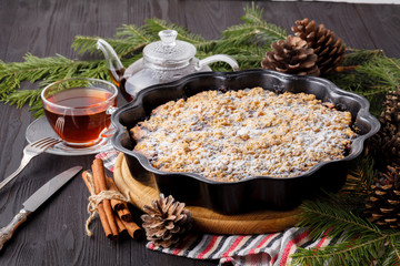 Traditional Christmas cake shtollen on a wood background