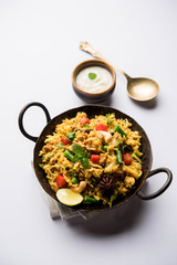 Kheema Pulao - Rice cooked with mutton or chicken mince with vegetables and spices. served in a bowl. selective focus