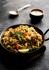 Kheema Pulao - Rice cooked with mutton or chicken mince with vegetables and spices. served in a bowl. selective focus