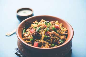 Kheema Pulao - Rice cooked with mutton or chicken mince with vegetables and spices. served in a bowl. selective focus