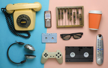 Retro objects on pastel background. Rotary telephone, audio cassette, video cassette, gamepad, 3d...