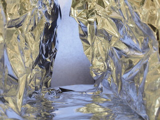 Passage between two rocks. Fantastic landscape of crumpled aluminum foil.