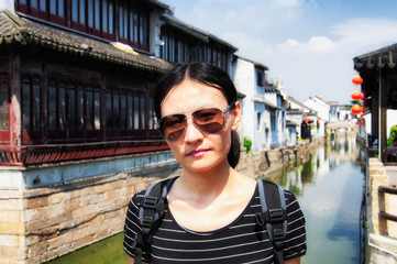 Chinese woman with Luzhi Water Town background