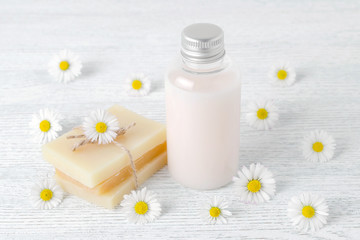 Obraz na płótnie Canvas natural hair shampoo, handmade soap bar with fresh chamomile flowers