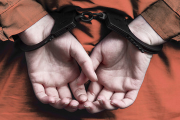 handcuffed hands behind his back. arrest, detention of the criminal, prison.