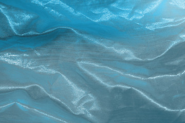 Obraz premium Ocean blue textile background. Silk cloth texture. Fabric jeans pattern.