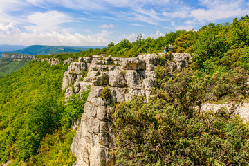 Fototapeta premium high beautiful stone cliff is a great platform for viewing the majestic beauty of the mountains and valleys of the Crimean Peninsula. Tourists love to visit this place