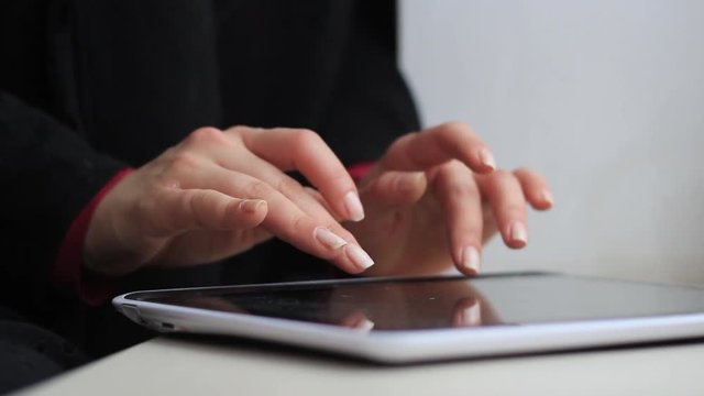 Women's hands work with a laptop