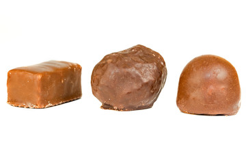 candies are covered with black chocolate isolate on a white background. chocolate candy isolate on a white background. Sweet chocolate candy isolated on white background
