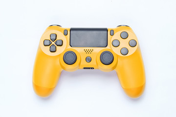 Modern yellow gamepad (joystick) on gray background. Top view.