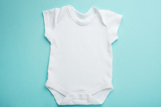 Layout Flat Wear a white baby body shirt, against a blue background. Layout for design and placement of logos, advertising