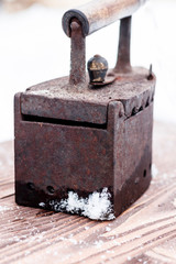 Ancient iron iron for ironing coals. Iron. on wooden background
