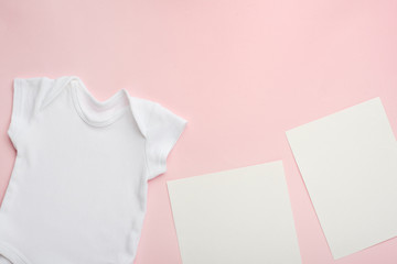 Layout Flat Lay a white baby bodysuit on a pink background, for a girl with white blank cards. Choose design and placement of logos, advertisements.