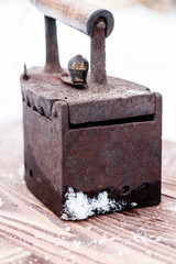 Ancient iron iron for ironing coals. Iron. on wooden background