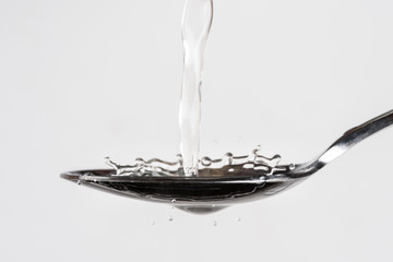 Pouring Coconut Water on a Spoon
