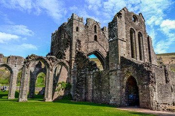 Fototapeta na wymiar Landmarks of Wales travel concept. View of ancient ruins of the castle/church in Brecon Beacons National Park, United Kingdom. Popular tourist attraction (Llanthony Priory,Hay-on-Wye, Black Mountains)