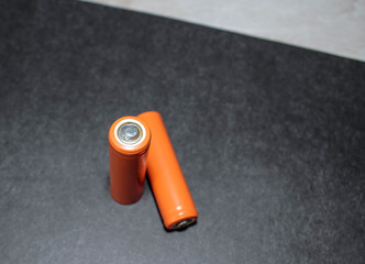 Two AA batteries on a black background.