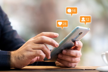 Man Checking His Social Media Account Using Smart Phone