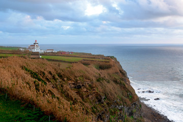 Fototapeta na wymiar Beautiful View over Atlantic Ocean with Lighthouse, Açores