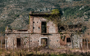 spooky house in winter mountain landscape