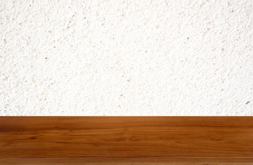 Tan wooden table on white background of cement wall textured- can be used for display or montage your product.