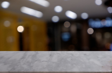 Empty white marble stone table in front of abstract blurred background of shopping mall, cafe and coffee shop interior. can be used for display or montage your products - Image.