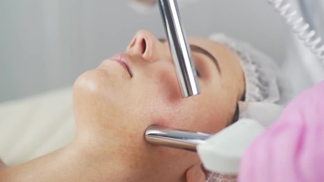 Beauty clinic. A woman gets beauty facial cosmetology procedure.
