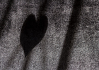 incarcerated heart shadow on black background