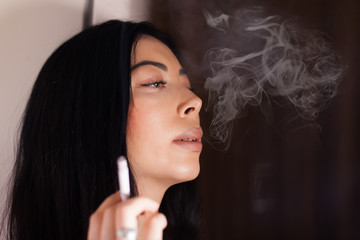 A beautiful woman is smoking