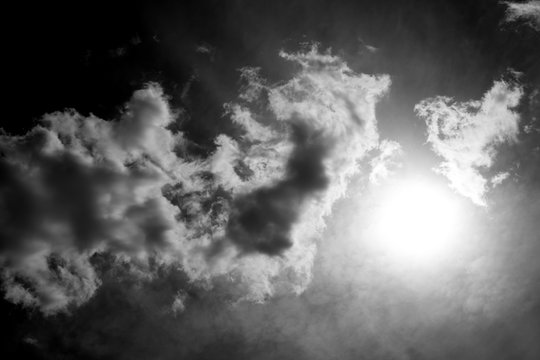 White fluffy clouds in the sky, black and white photo