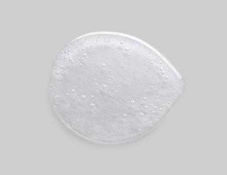 Cosmetic liquid gel collagen serum on grey background.