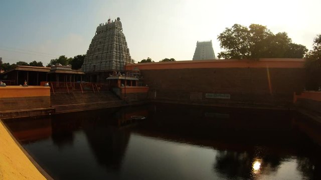 Pond in yard of southern Indian temple complex Tiruvannamalai big gates tower around