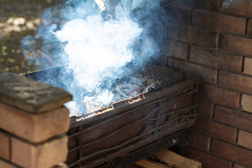 Smoke comes from the brazier, trimmed with stone.