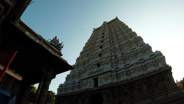 Majestic gate tower of ancient temple complex Tiruvannamalai blue sky sunny day
