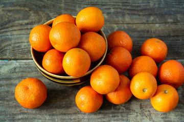 A lot of tangerines on a wooden background.