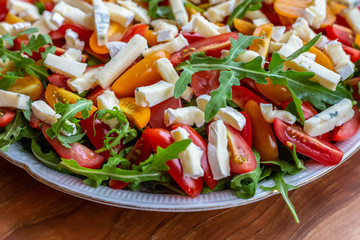 Salad with tomatoes, blue cheese, arugula and sunflower seeds