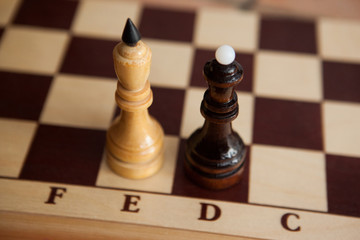 The white king and black queen are standing on a chessboard. Checkmate